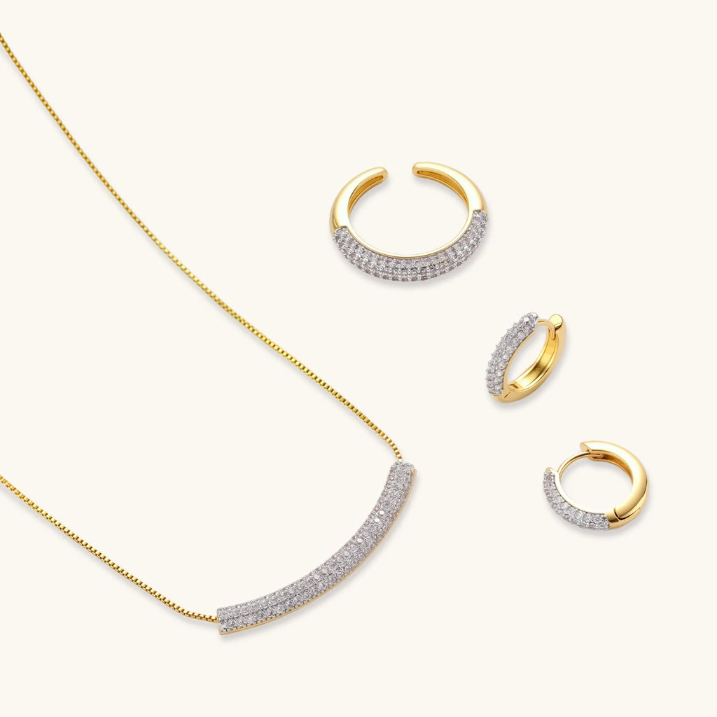 Crescent Glow Set gold pavé necklace and earrings on white background