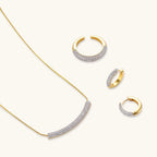 Crescent Glow Set gold pavé necklace and earrings on white background