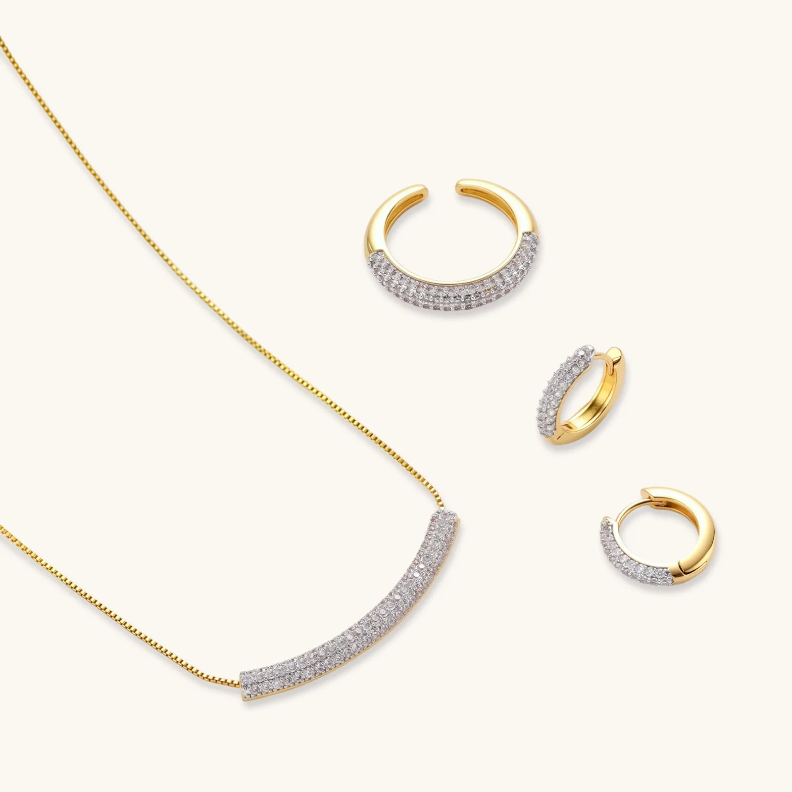 Crescent Glow Set gold pavé necklace and earrings on white background