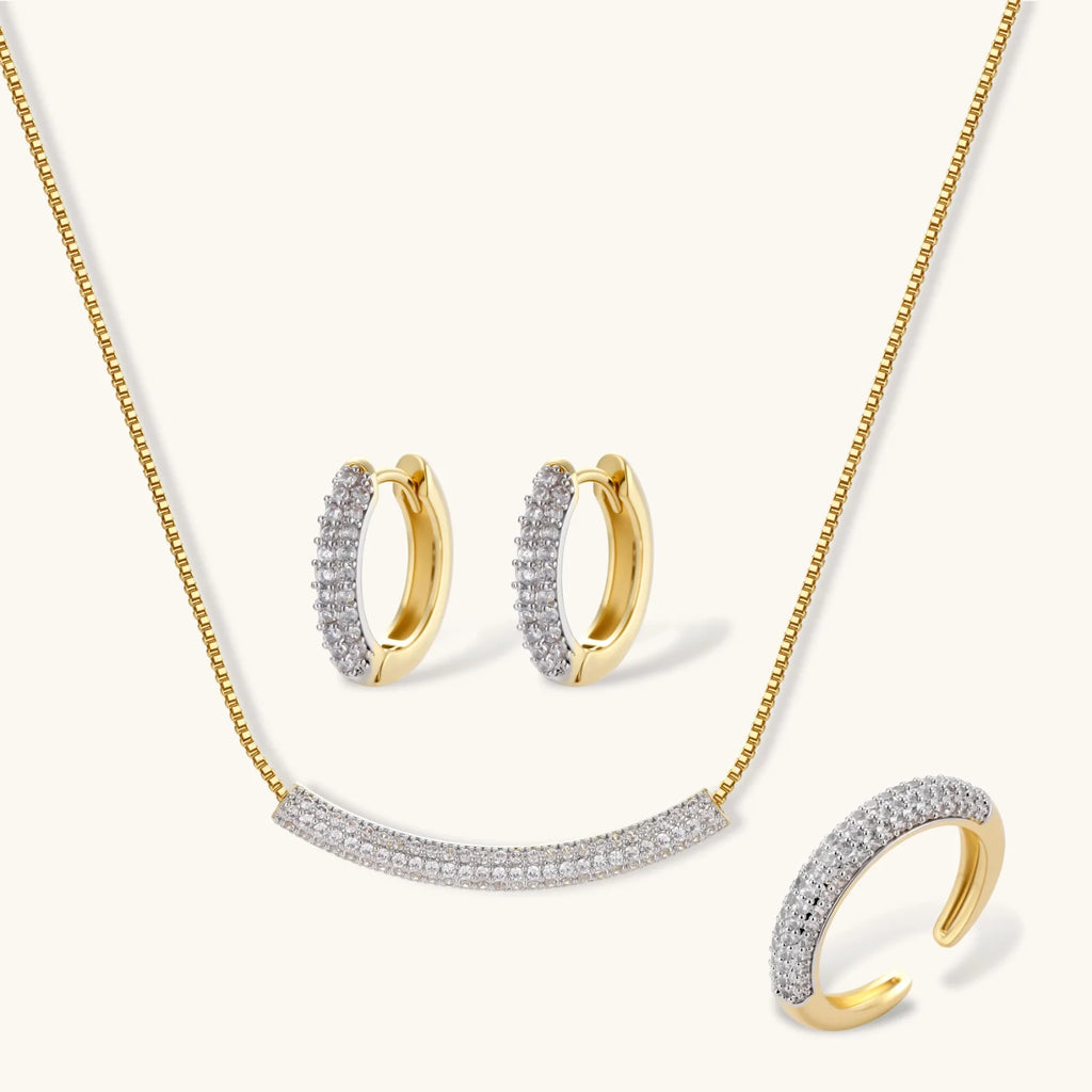 Crescent Glow Set gold pavé necklace, earrings, and ring on white background