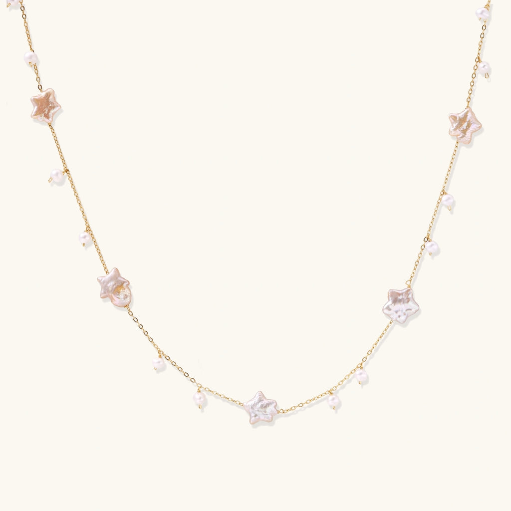 Celestial Pearl Stars Necklace with star-shaped pearls on plain background