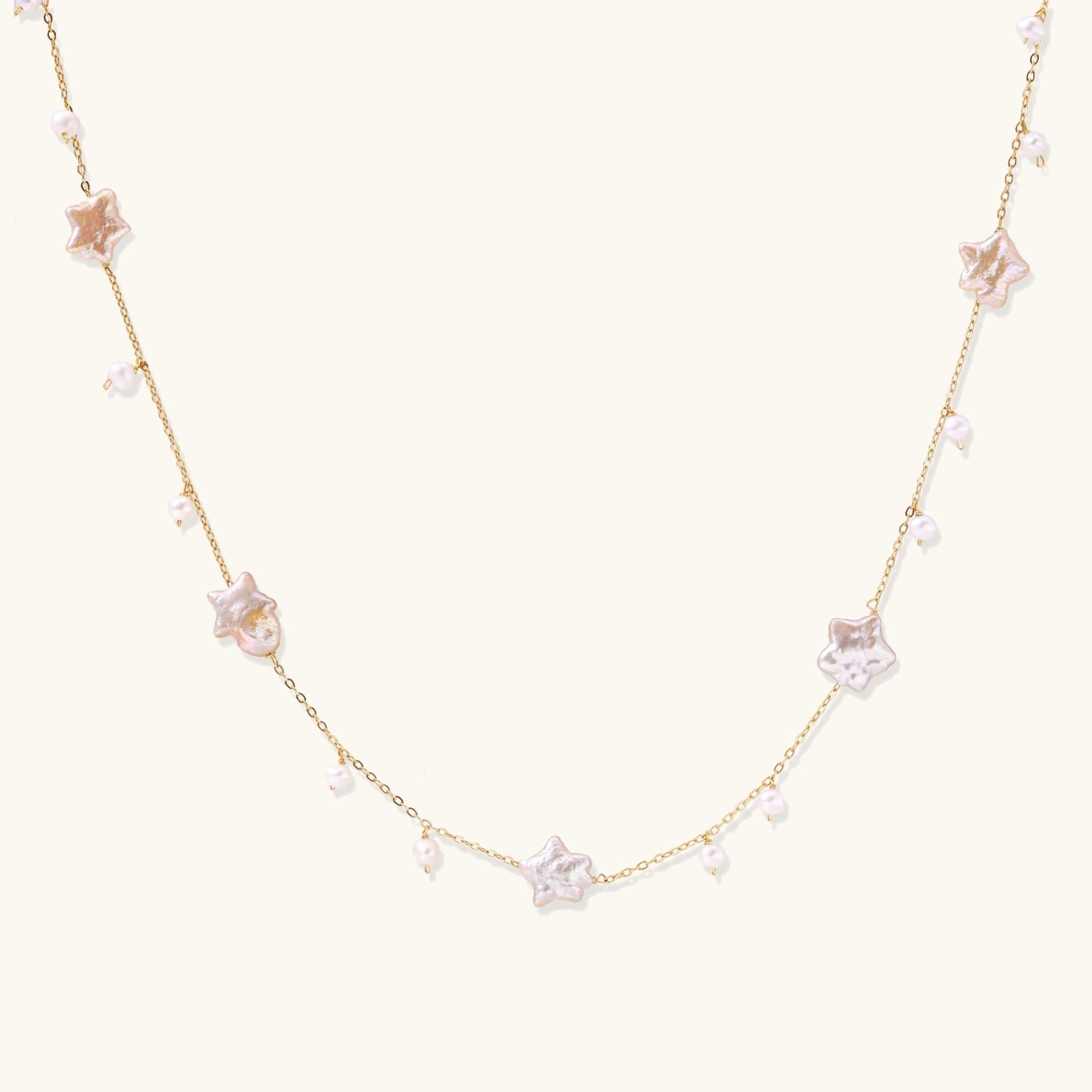 Celestial Pearl Stars Necklace with star-shaped pearls on plain background