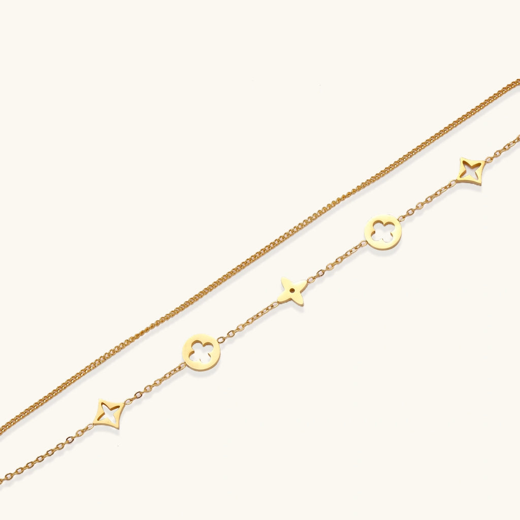 Lucky Star Charm Bracelet gold chain with star and clover charms on white background