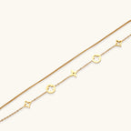 Lucky Star Charm Bracelet gold chain with star and clover charms on white background