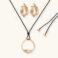 Cosmic Circle Set gold necklace and earrings on white background