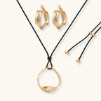 Cosmic Circle Set gold necklace and earrings on white background