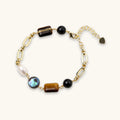 Earth Elements Bracelet with gold chain and mixed stones on white background
