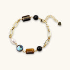 Earth Elements Bracelet with gold chain and mixed stones on white background